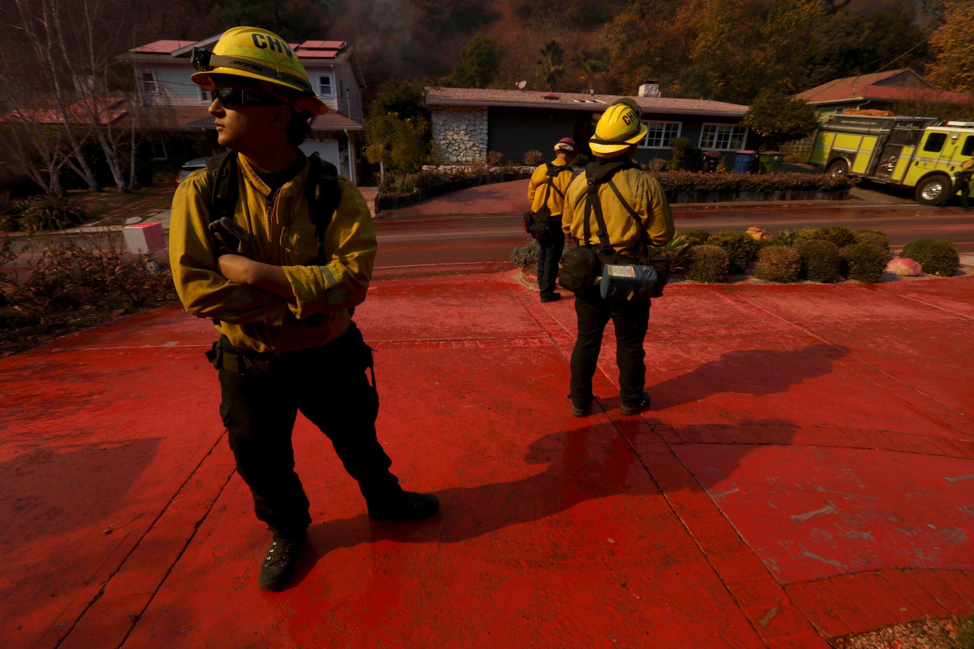 Chula Vista firefighters keep an eye on the Palisades blaze after a phosphorus drop in Mandeville Canyon in Brentwood.