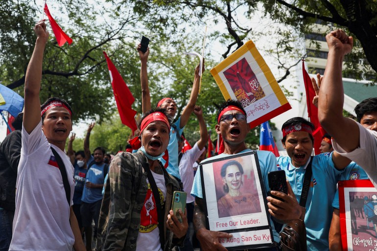 Protesters hold up a portrait of Aung San Suu Kyi and raise three-finger salutes during a demonstration to mark the third anniversary of Myanmar's 2021 military coup, outside of the United Nations office in Bangkok, Thailand, February 1, 2024. REUTERS/Chalinee Thirasupa