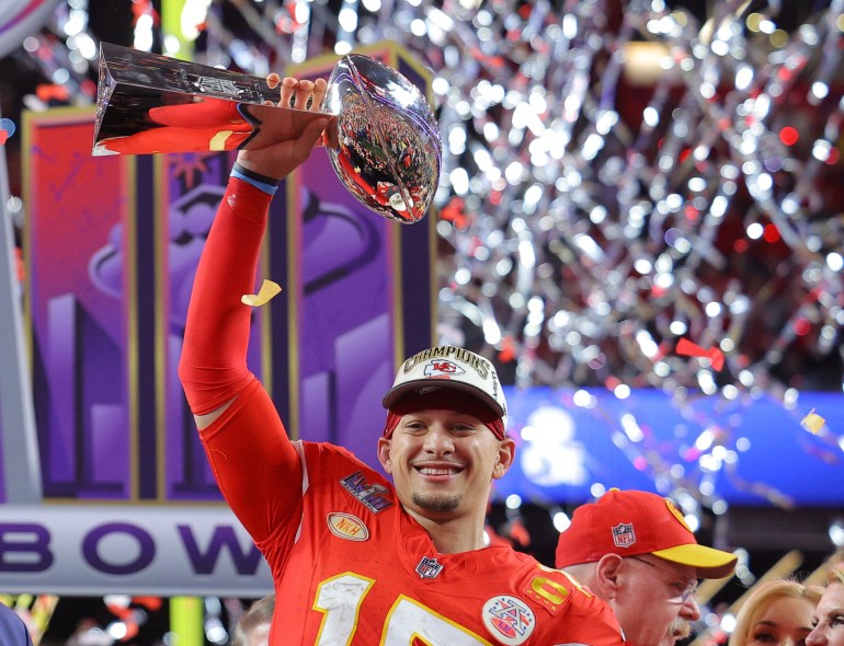 Patrick Mahomes holds the Vince Lombardi Trophy.