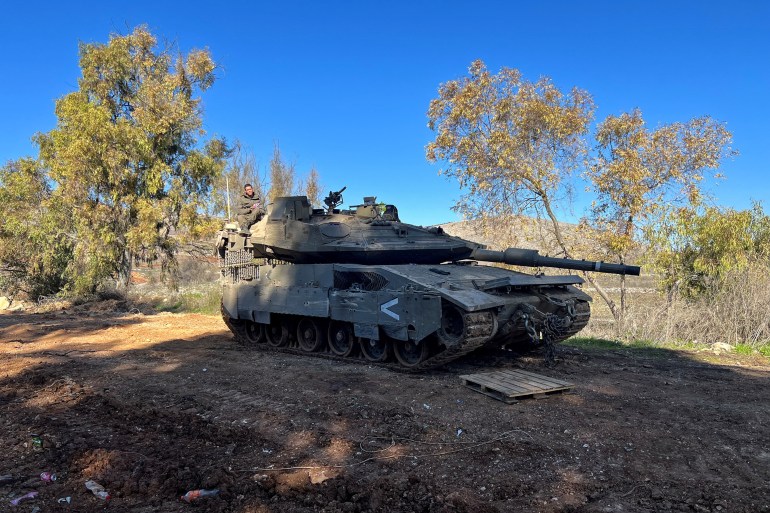 An Israeli soldier sits on top of a tank as it stands by near the Israel-Lebanon border in northern Israel, January 18, 2025. REUTERS/Avi Ohayon