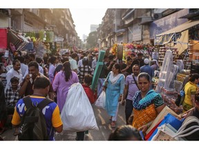 Pedestrians at Zaveri Bazaar during the festival of Dhanteras in Mumbai, India, on Tuesday, Oct. 29, 2024. Dhanteras is traditionally seen as the most auspicious day in the Hindu calendar to buy gold, with many shops remaining open until midnight and jewelers offering discounts and gifts. Photographer: Dhiraj Singh/Bloomberg