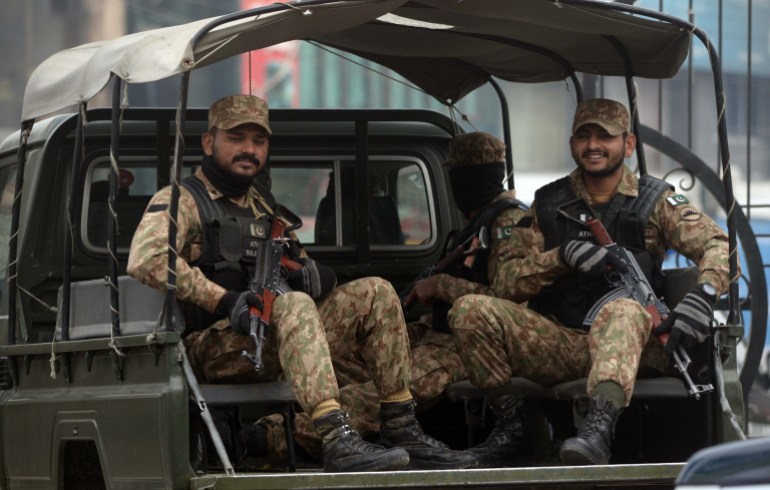 Military guards sitting in a truck.