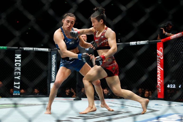 Tatiana Suarez and Zhang Weili in the Octagon.