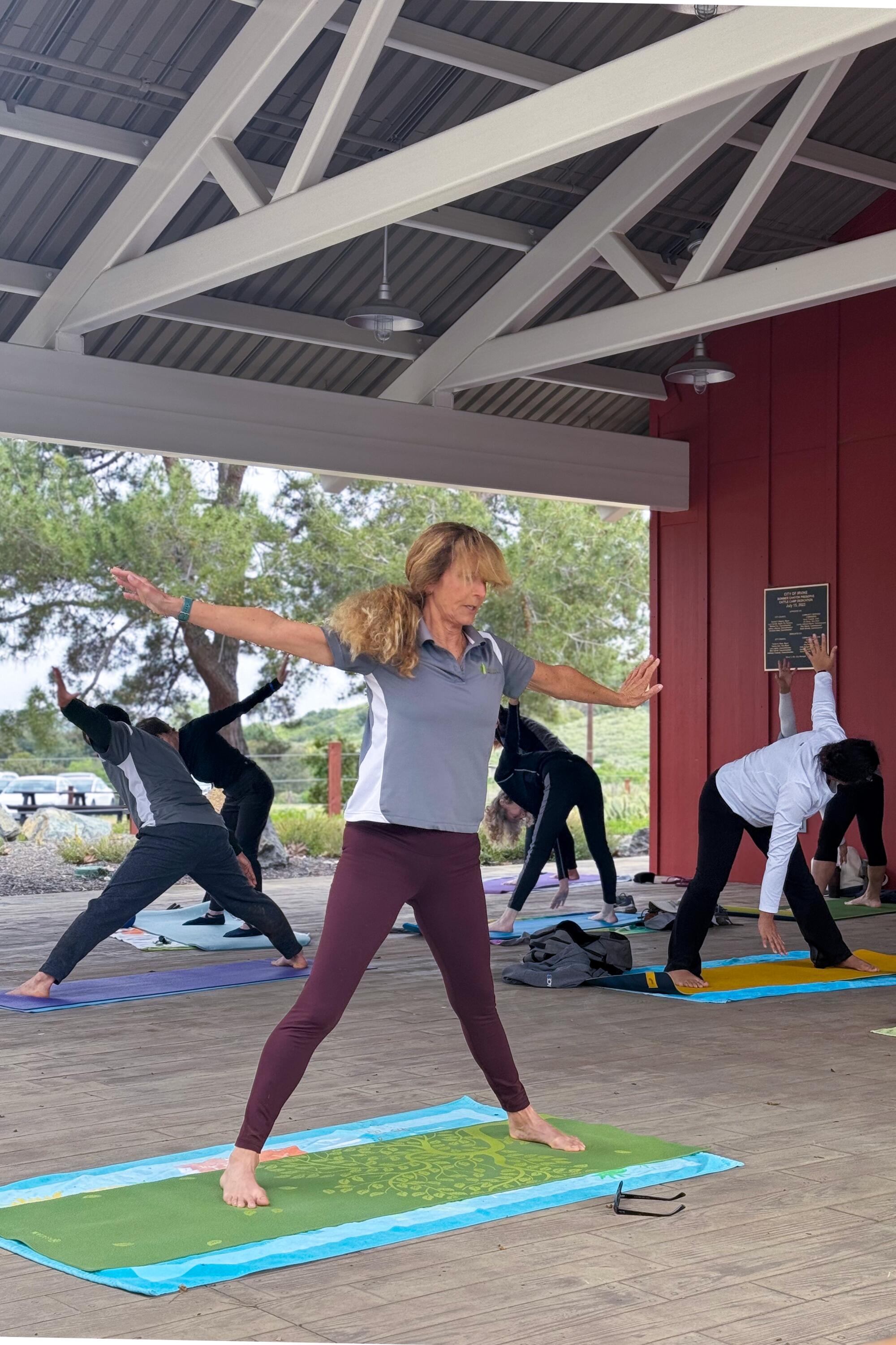 A group doing yoga in an open-air structure.