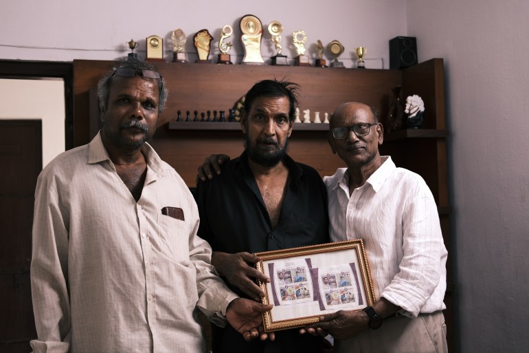 Jayem Vallur (left), suffered a near-fatal road accident, and credits chess and his close friends Unnikrishnan (middle) and Baby John (right), with helping him mostly recover from the resulting paralysis [Mirja Vogel/ Al Jazeera]