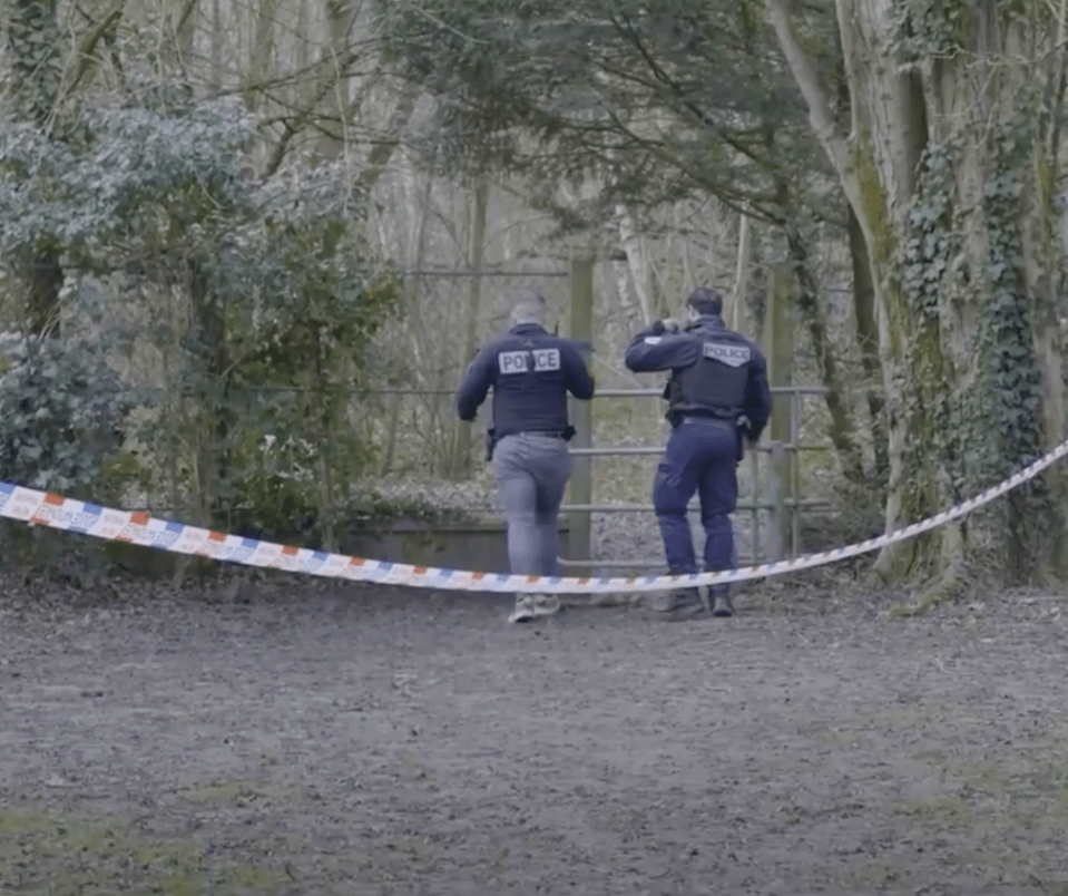 Two police officers at a crime scene.