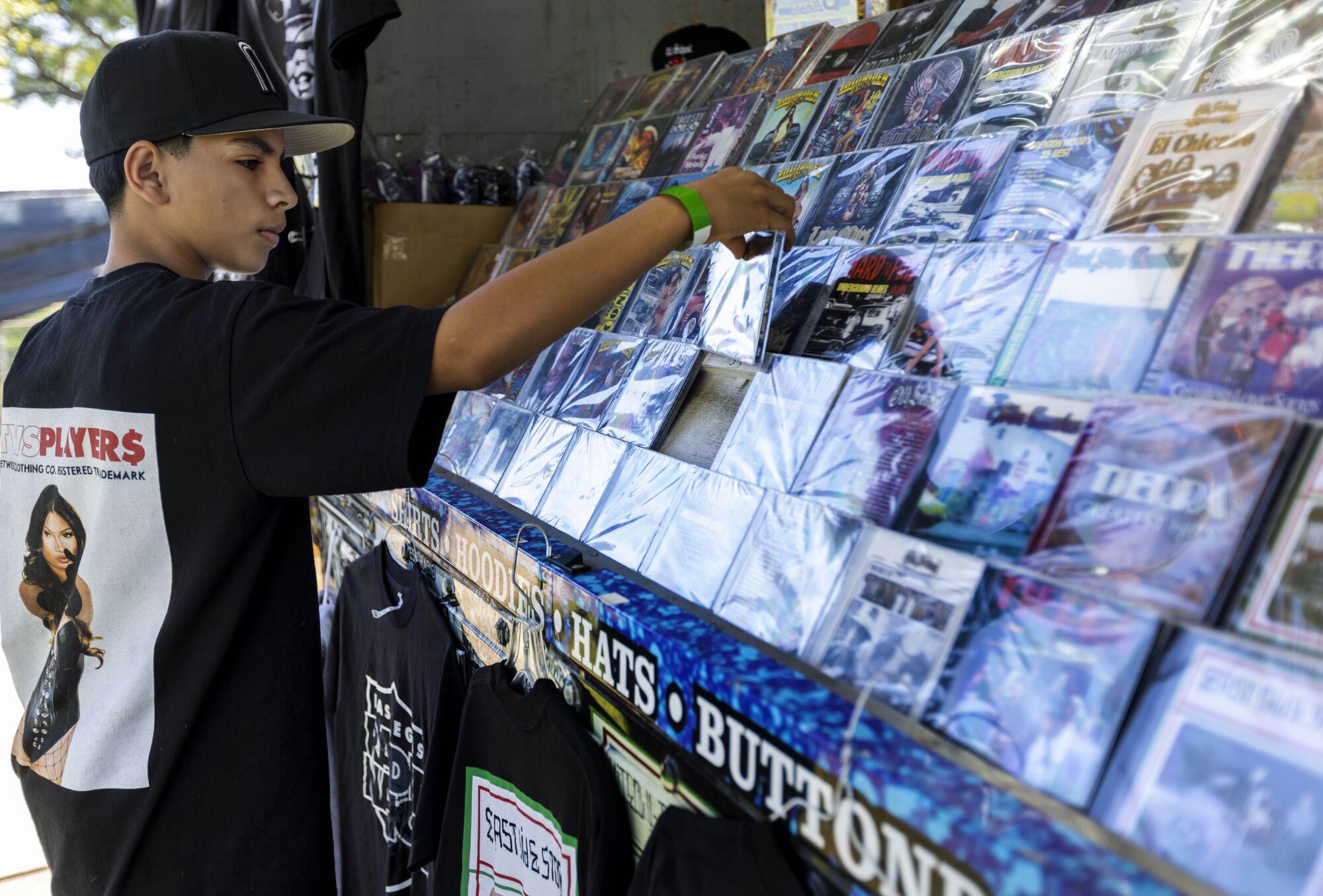 Jacob Mora, 11, of La Puente looks at a CD at the Thump Records Truck