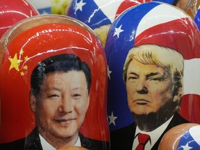 FILE - Traditional Russian wooden dolls called Matryoshka depicting China's President Xi Jinping, left, and U.S. President Donald Trump are on sale at a souvenir shop in St. Petersburg, Russia, on Nov. 21, 2024.