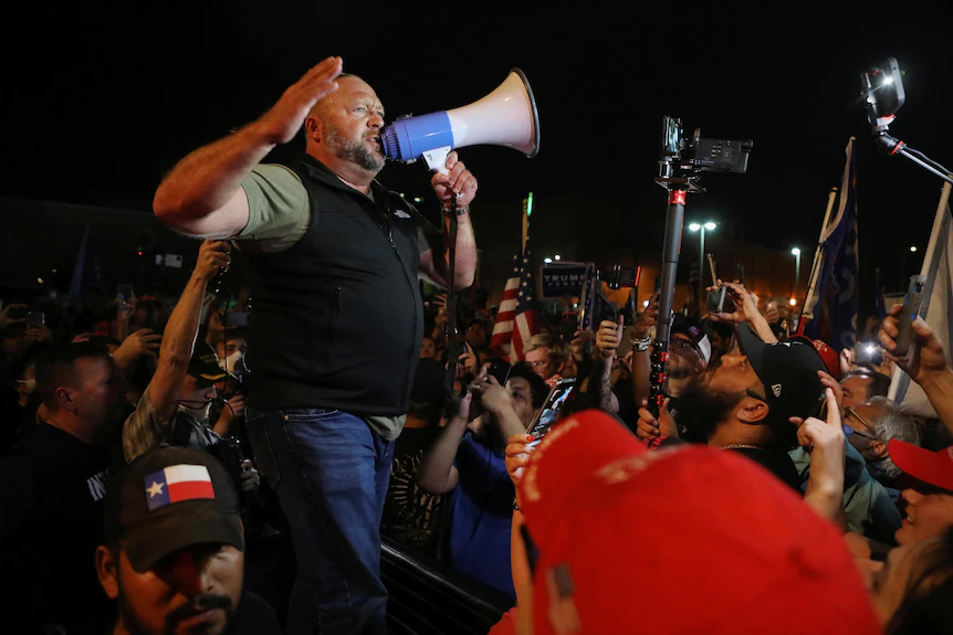 Alex Jones speaks into a loudspeaker at a pro-Trump protest against the election result in 2020.