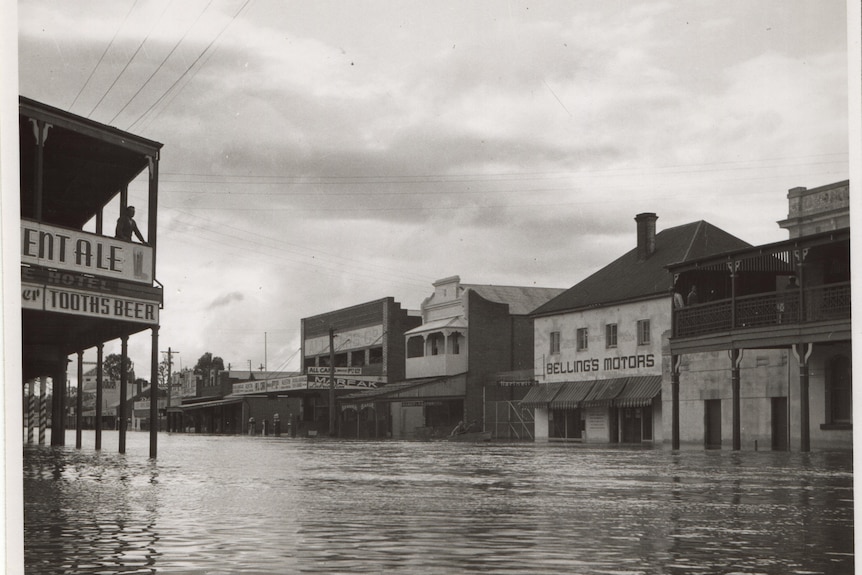 A black-and-white photograph of a flooded country town in the 1950s