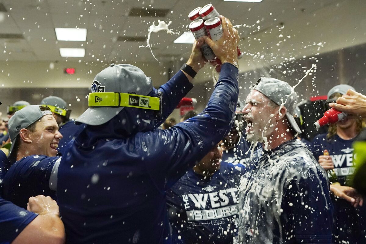 Dodgers players celebrate clinching the NL West title with a victory over the Arizona Diamondbacks on Sept. 13, 2022.