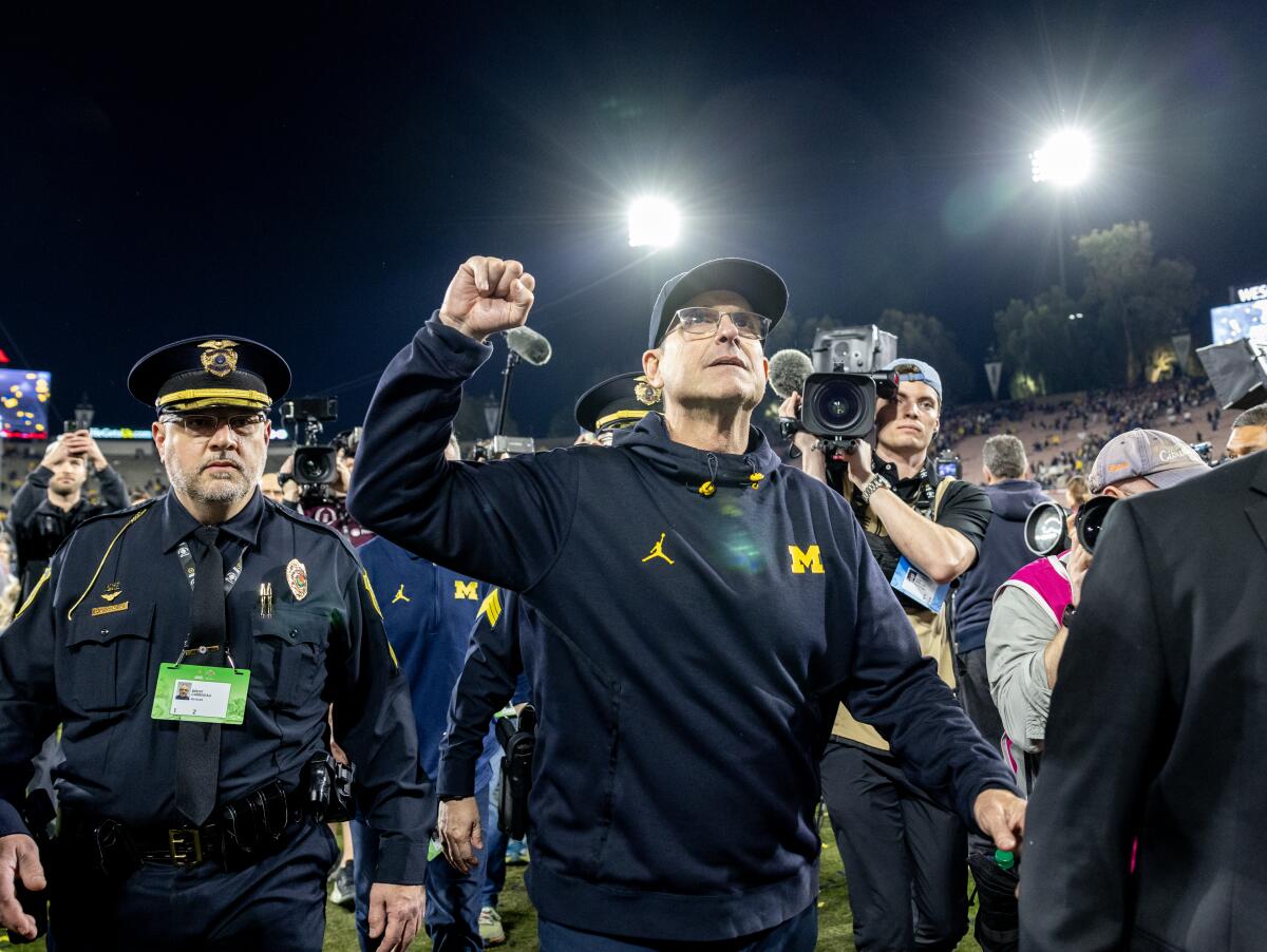 Michigan coach Jim Harbaugh leaves the field after the Wolverines' win over Alabama in the Rose Bowl on Monday.