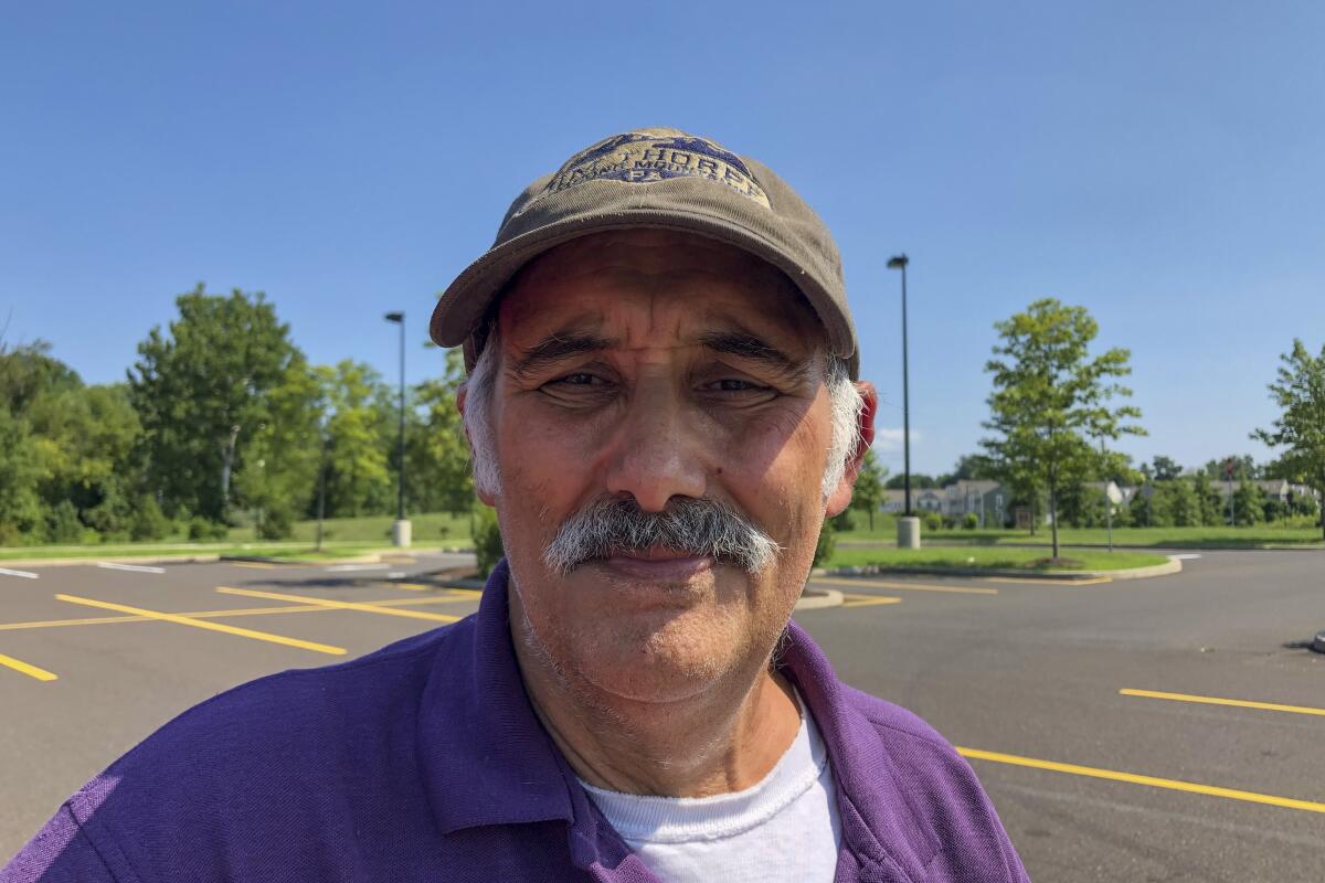 David Forcellini poses for a portrait in a parking lot