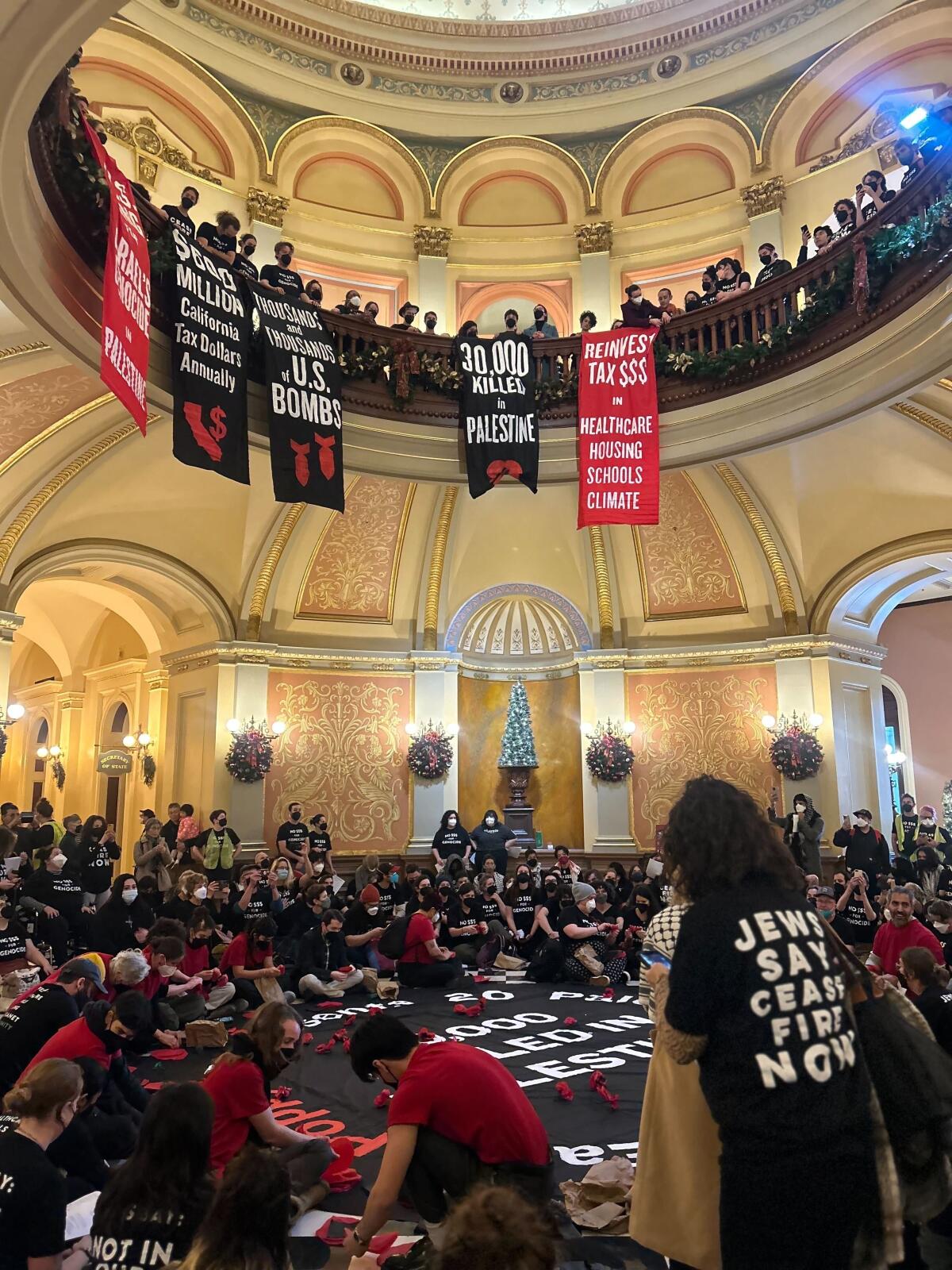 Protesters hang banners in a building.