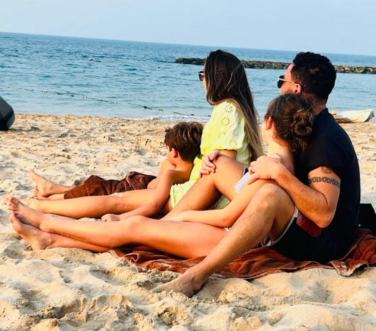 The doctor, 34, shared a beach snap with their two kids