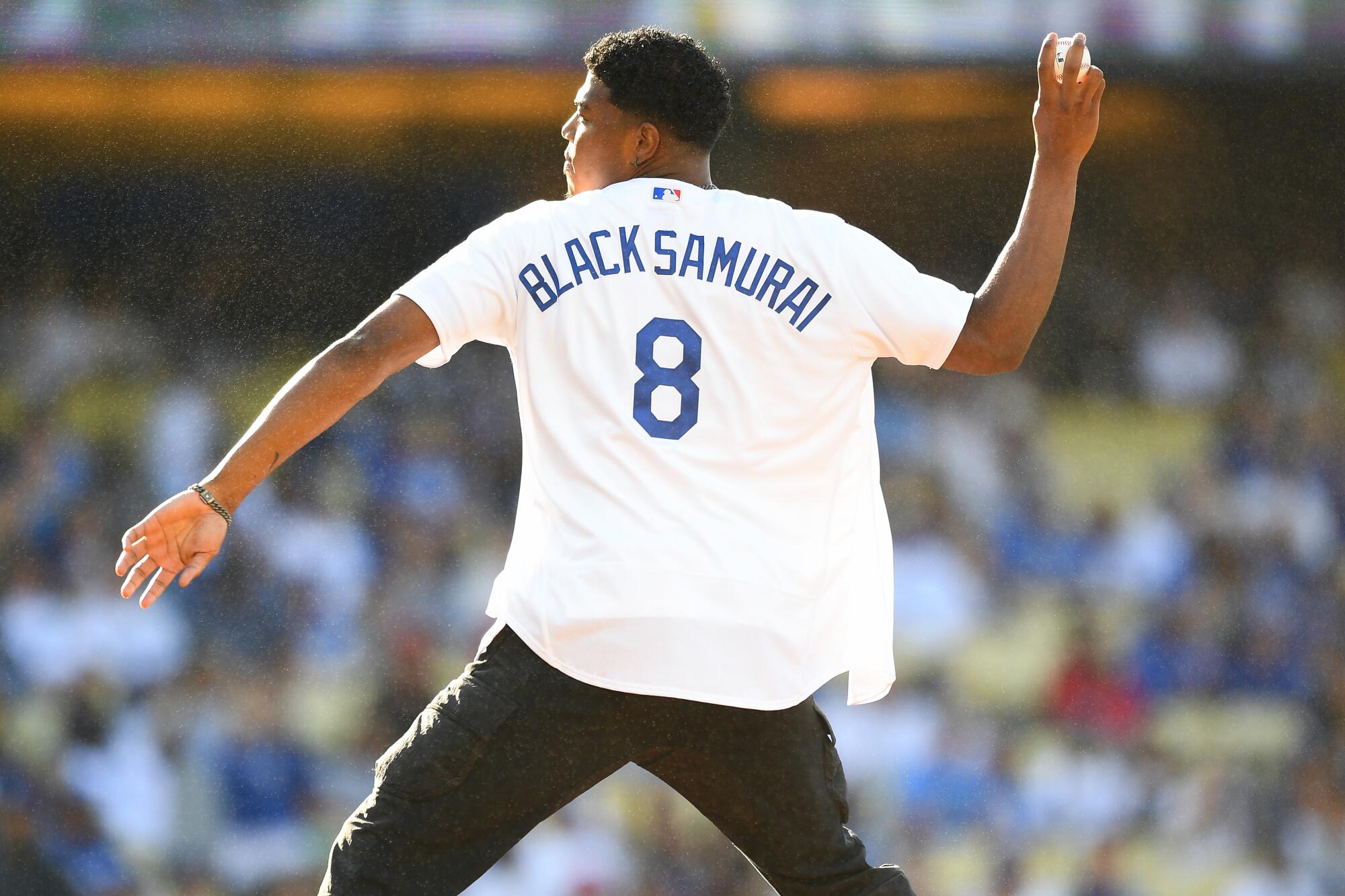 Lakers forward Rui Hachimura delivers the ceremonial first pitch before a Dodgers-Angels game last July at Dodger Stadium.