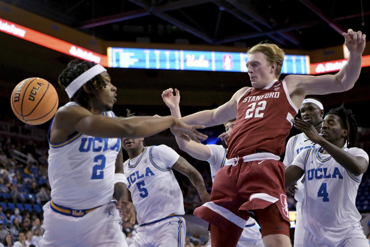 UCLA guard Dylan Andrews (2) and Stanford Cardinal James Keefe (22) go for a rebound Wednesday at Pauley Pavilion.