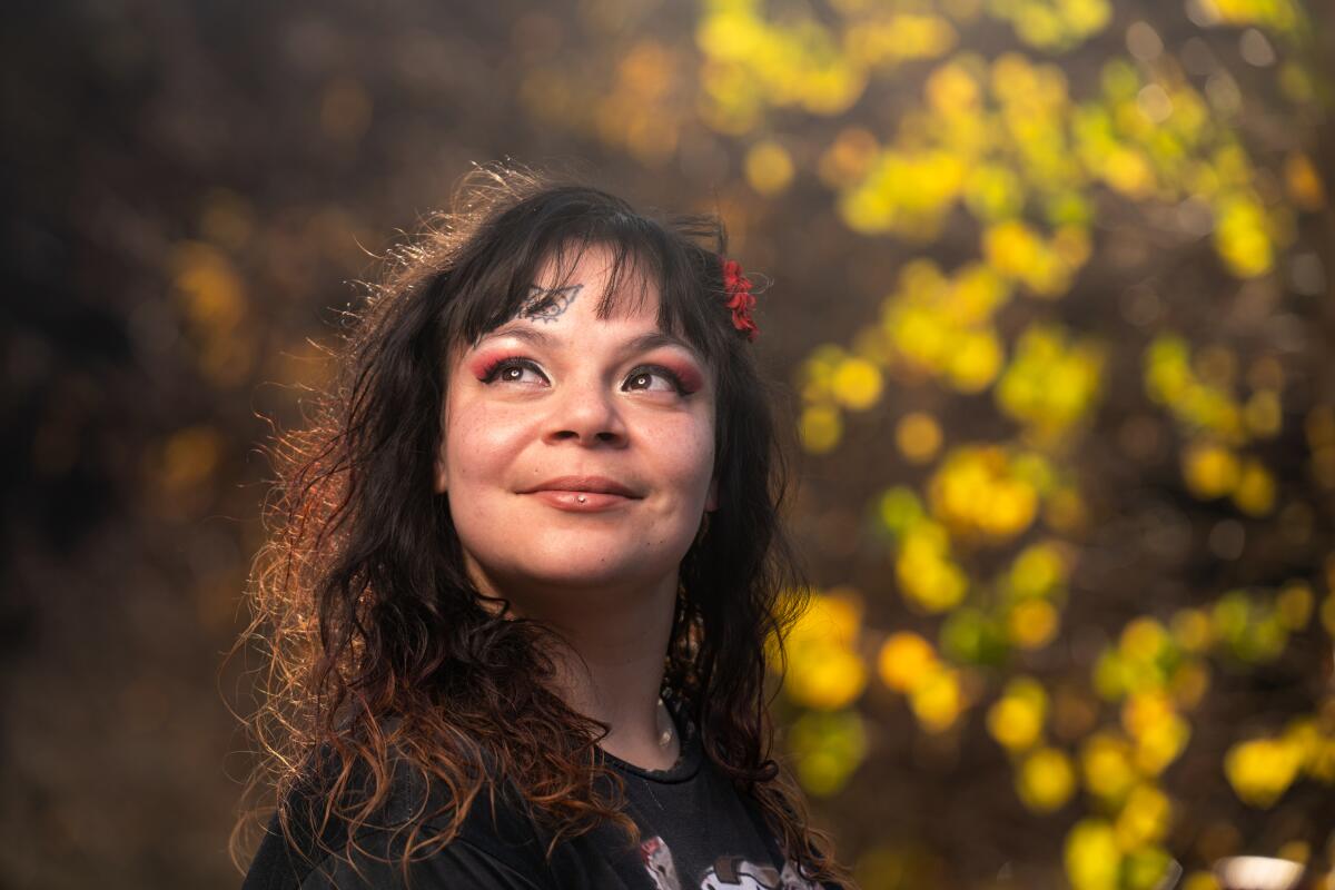 A smiling woman outdoors.