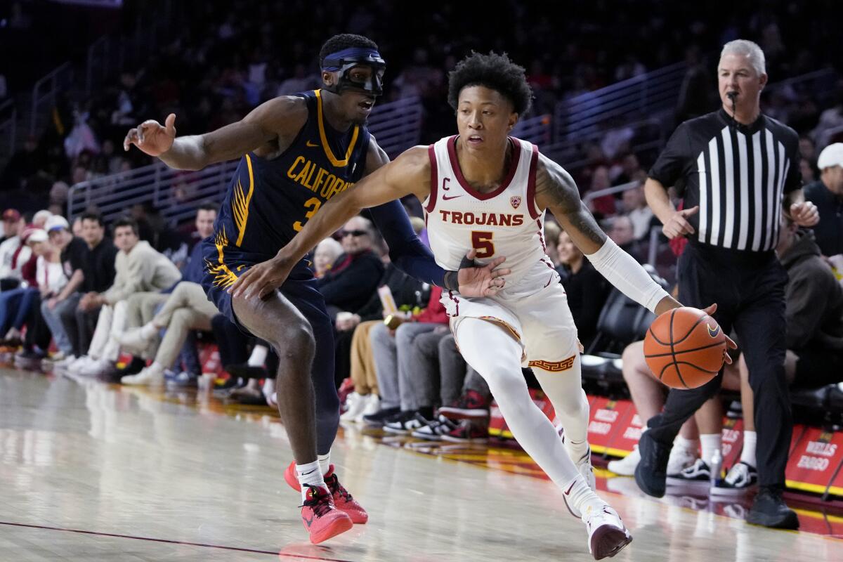 USC guard Boogie Ellis dribbles by California guard Keonte Kennedy on Wednesday at the Galen Center.