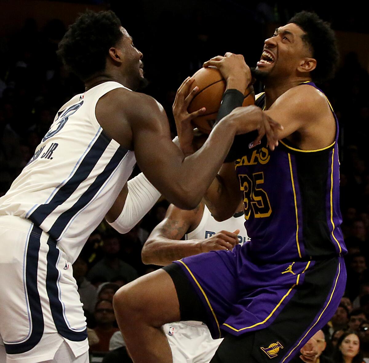 Lakers forward Christian Wood is fouled by Memphis forward Jaren Jackson Jr. in the second half Friday.