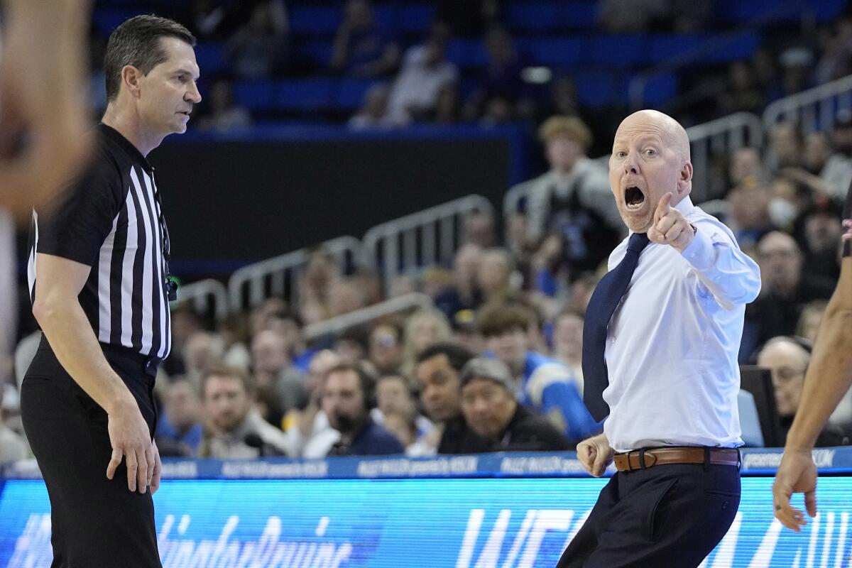 UCLA coach Mick Cronin, right, yells at a referee during the first half of the Bruins' loss to California at Pauley Pavilion.