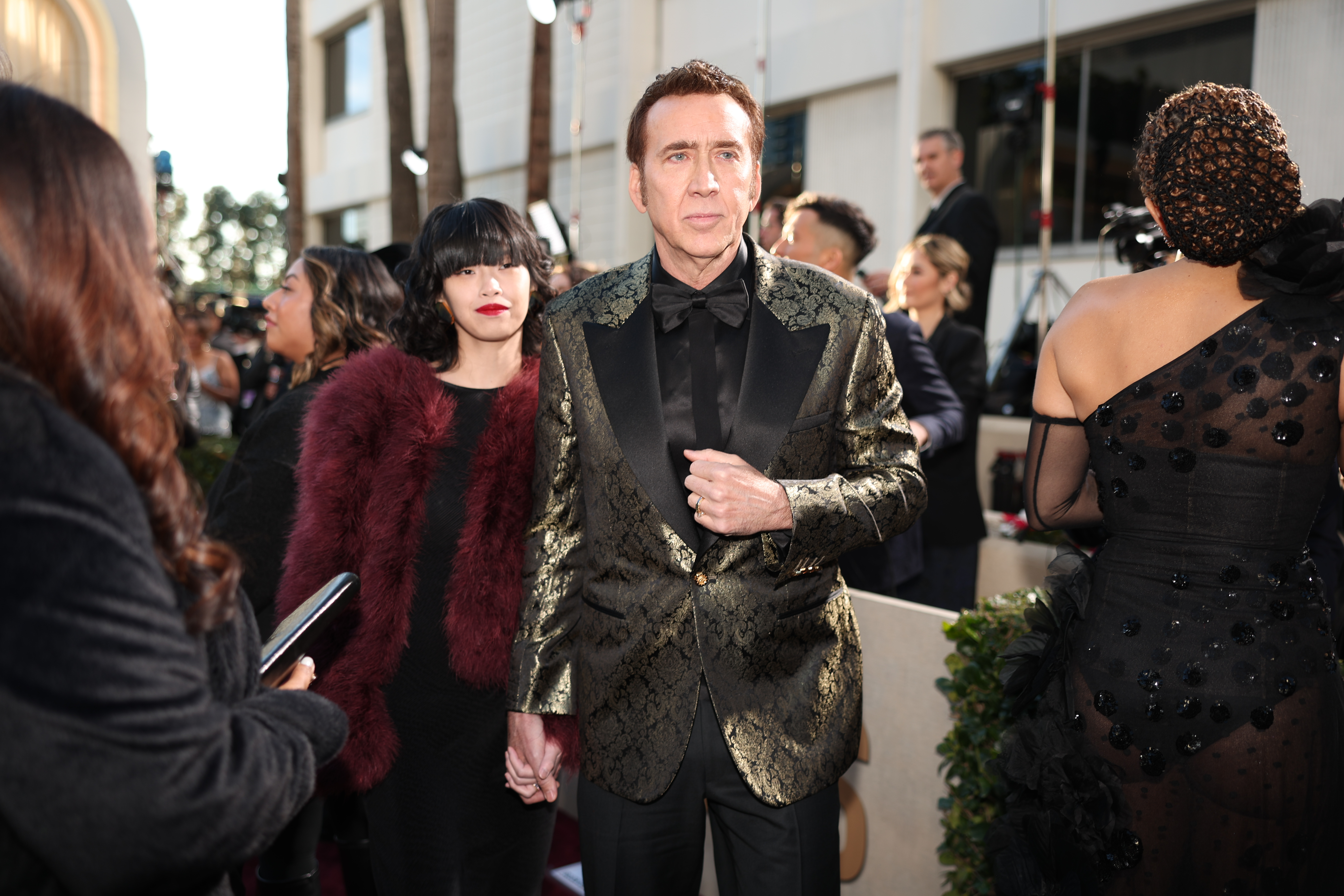 Nicolas Cage and Riko Shibata arrive at the Golden Globes red carpet