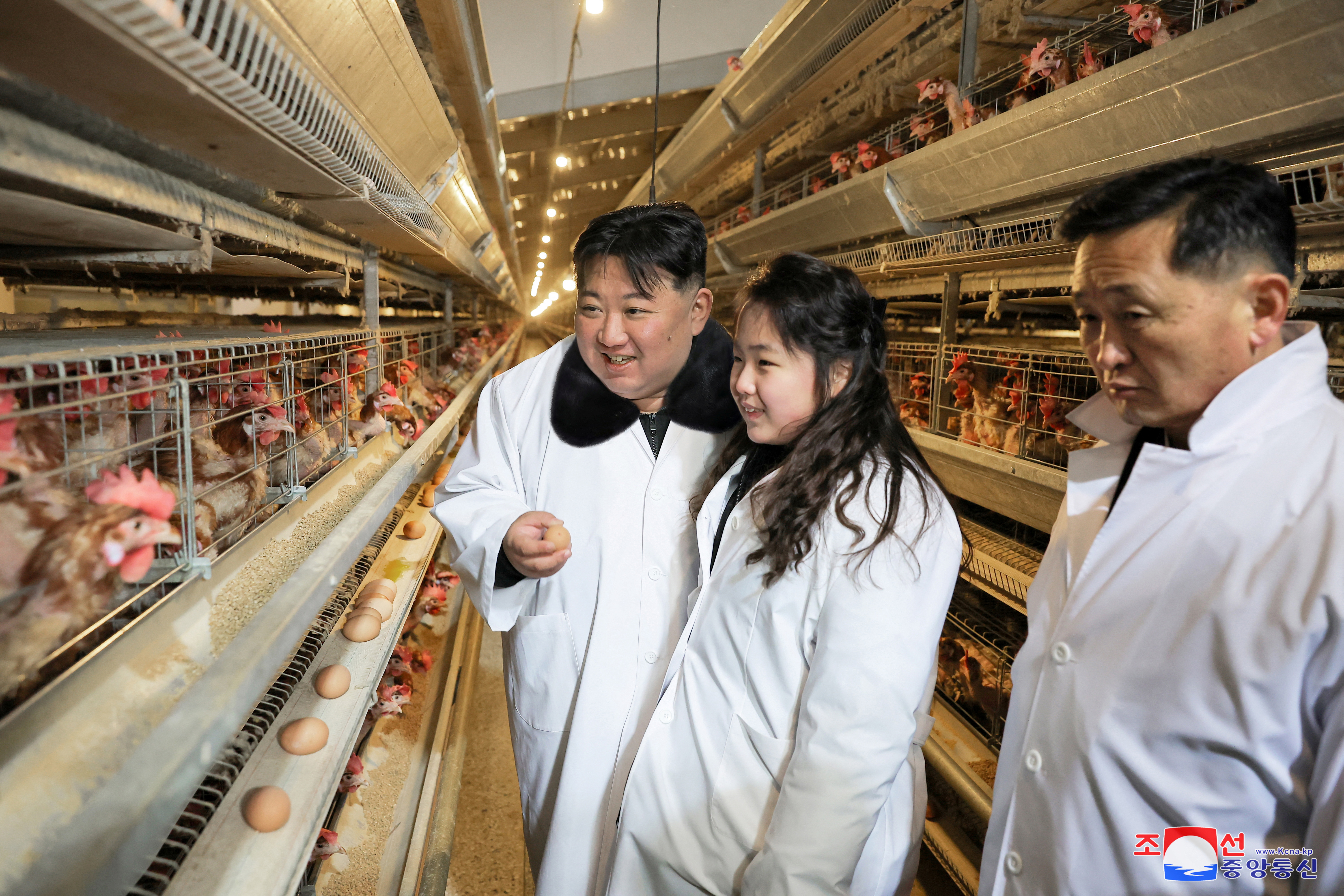 Kim and his daughter Kim Ju-ae visit the Kwangchon Chicken Farm near Pyongyang on January 7