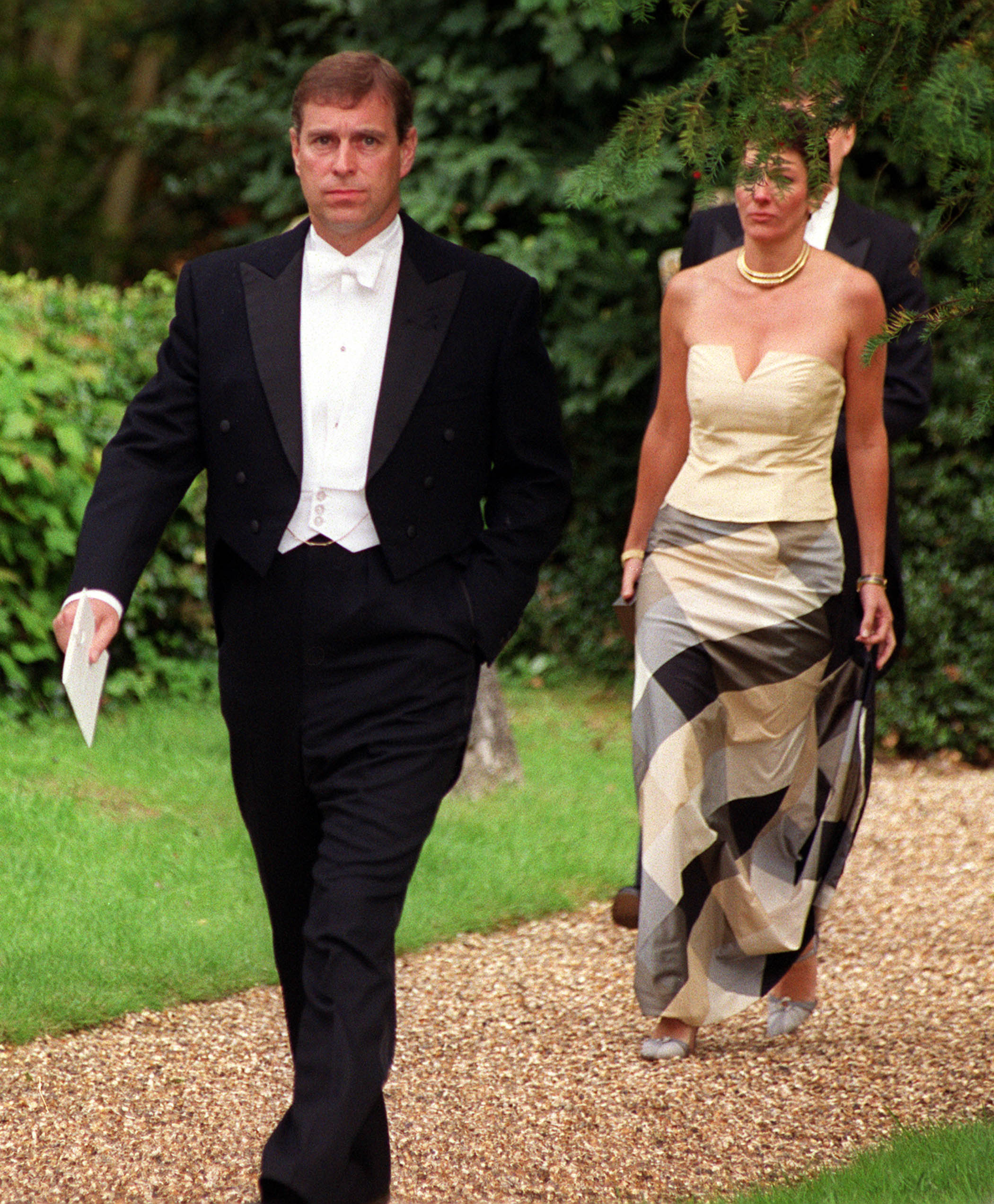 Prince Andrew walks ahead of the Ghislaine at a wedding in 2000