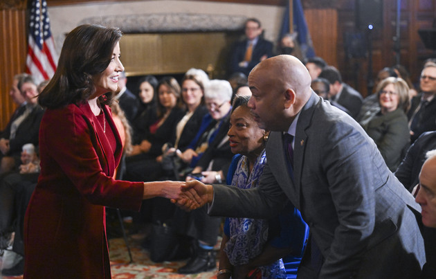 Kathy Hochul, left, greets Carl Heastie.