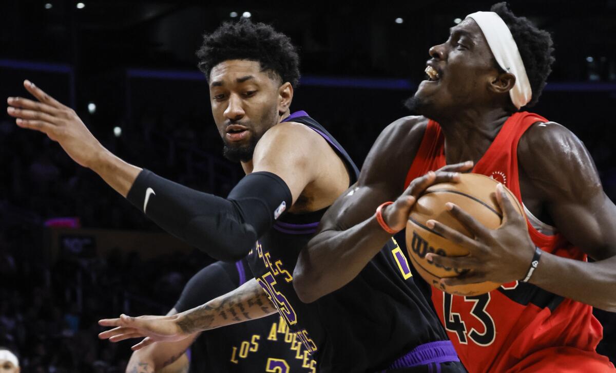 Lakers forward Christian Wood defends against Raptors forward Pascal Siakam in the first half.