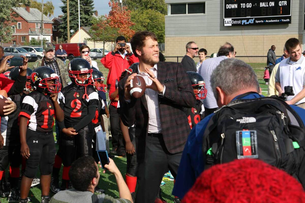 Stafford throws the football to kids at the SAY Detroit Play Center.