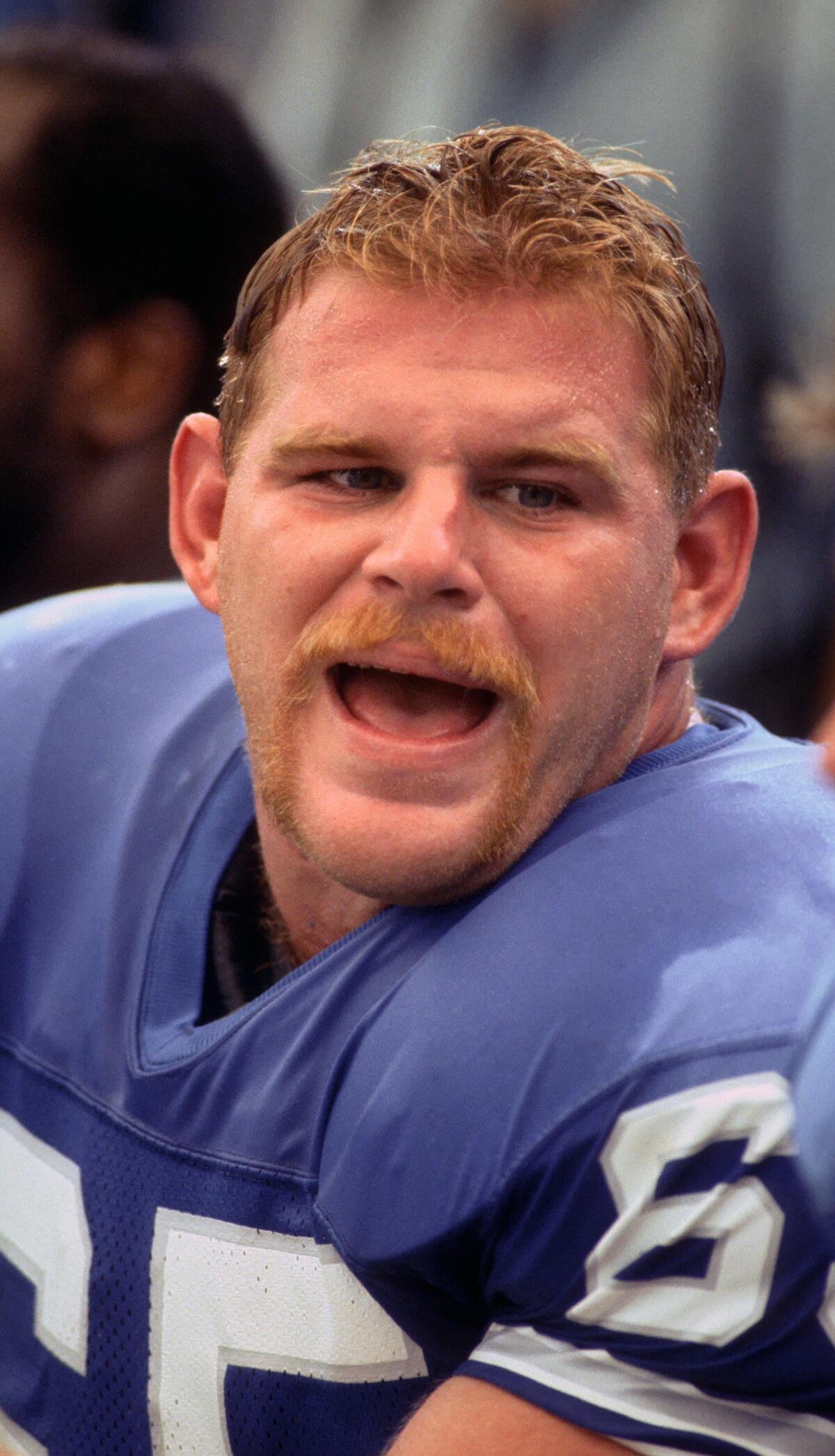 Lions offensive lineman Eric Andolsek talks on the bench.