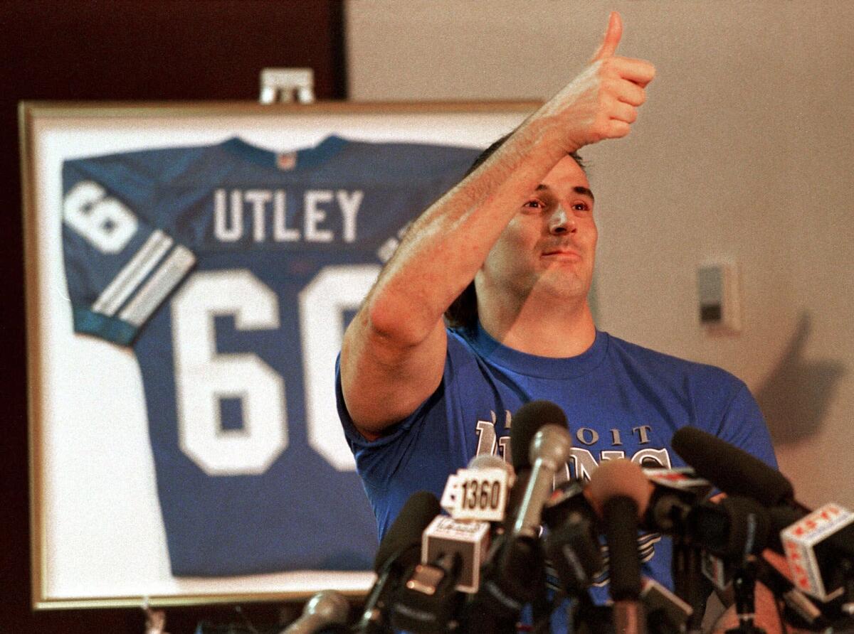 Former Lions guard Mike Utley gives the thumbs-up after walking assisted from his wheelchair on Dec. 6, 2016. 