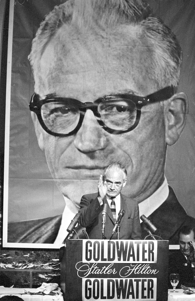 Sen. Barry Goldwater, standing before a huge portrait of himself, addressed Texas Republicans at a dinner in 1964.