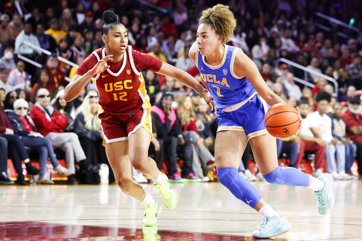 UCLA guard Kiki Rice controls the ball in front of USC guard JuJu Watkins during the first half.