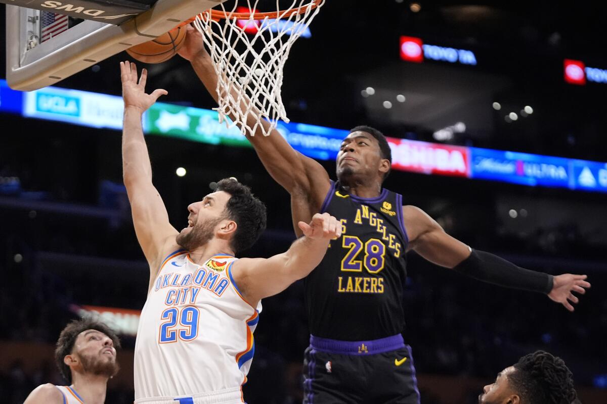 Oklahoma City Thunder guard Vasilije Micic tries to shoots as Lakers forward Rui Hachimura defends.