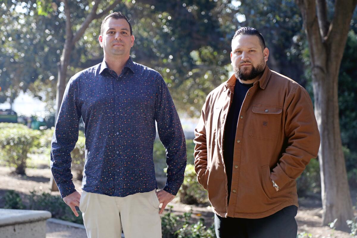 Two men standing outdoors.