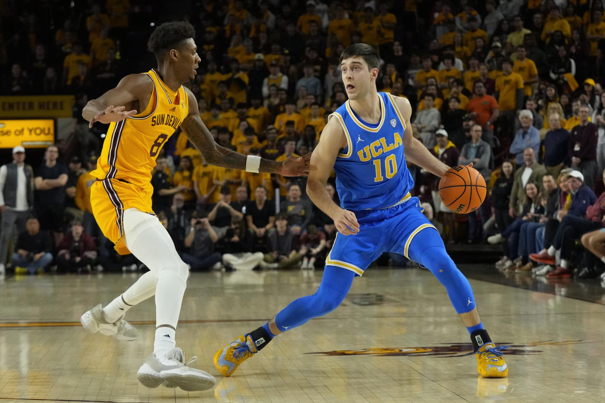 UCLA guard Lazar Stefanovic controls the ball in front of Arizona State forward Alonzo Gaffney.