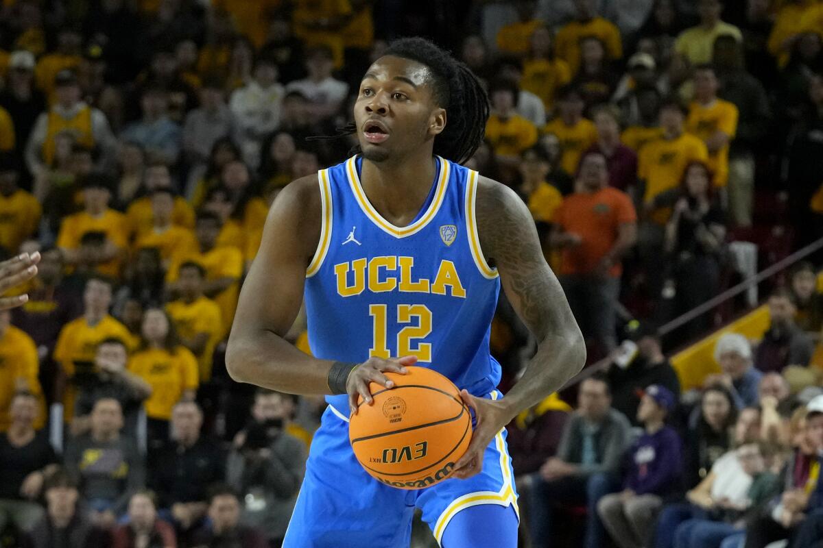 UCLA guard Sebastian Mack looks to pass the ball.