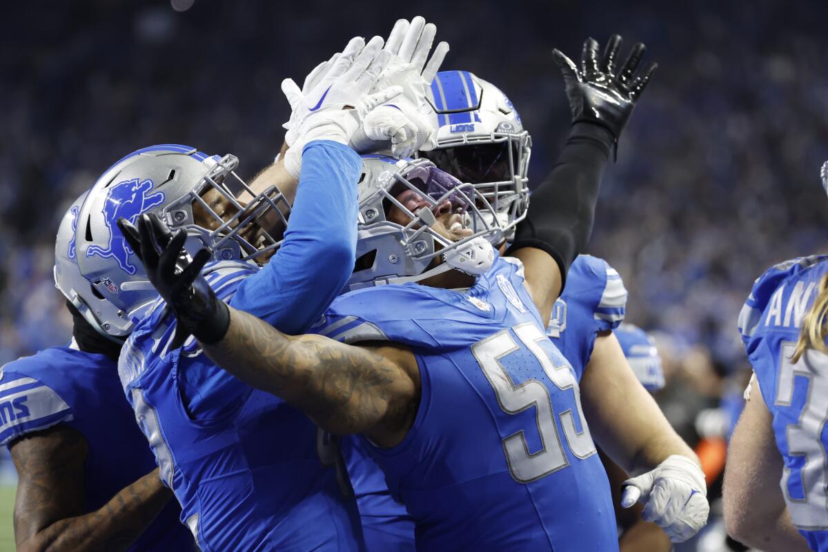 Detroit linebacker Derrick Barnes celebrates after intercepting a pass from Buccaneers quarterback Baker Mayfield.