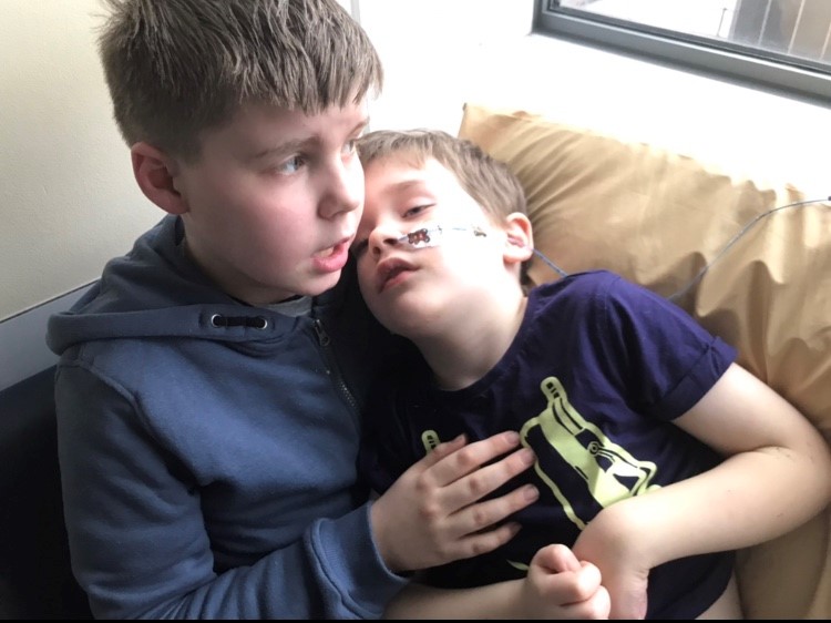 Freddie (left), cradling Samuel just a few days before he slipped into a coma