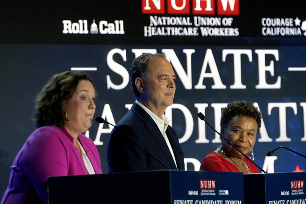 Reps. Adam Schiff, Katie Porter, and Barbara Lee stand on stage behind podiums.