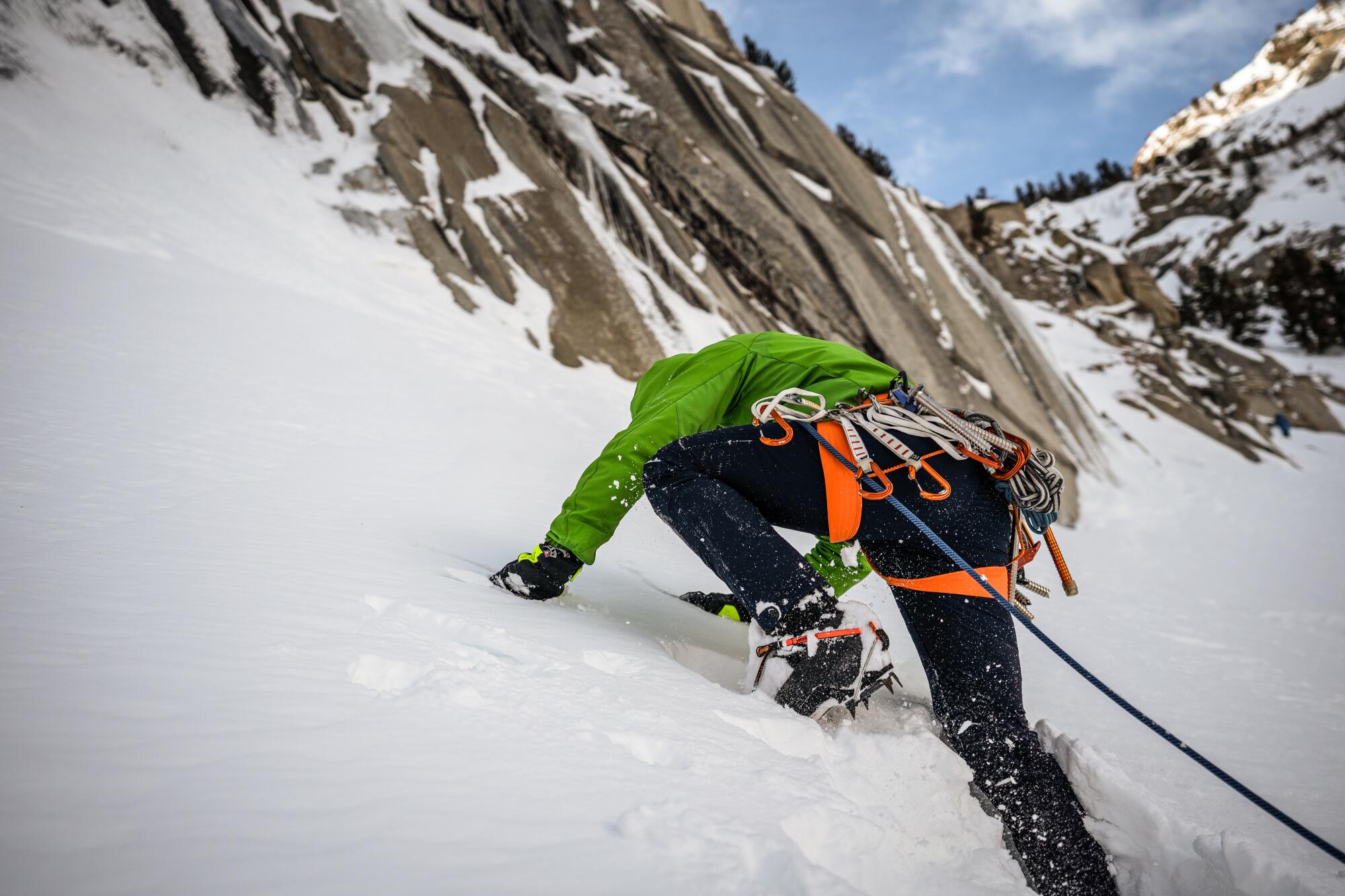 A person wearing crampons walks up a snowy mountain. (Richard Bae / For The Times)