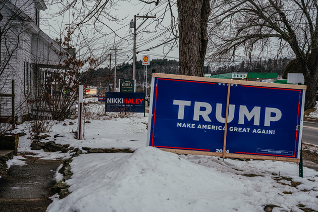 A Nikki Haley and Donald Trump sign sit in yards next door to each other in Derry, New Hampshire.