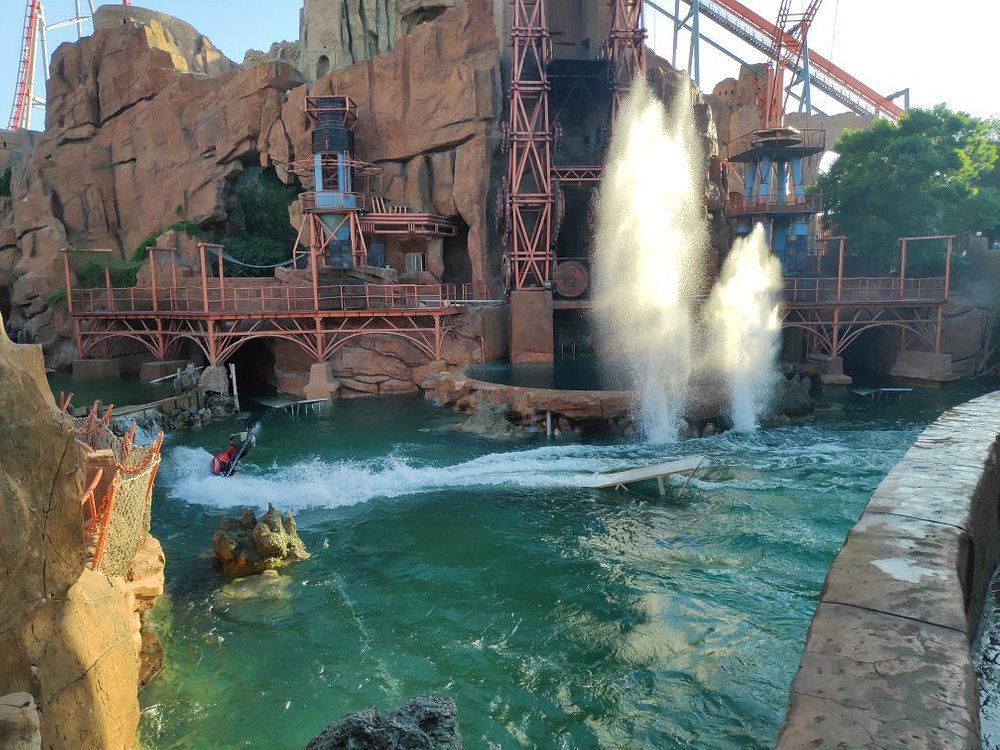 A murky green pool of water around a castle is the park's main attraction