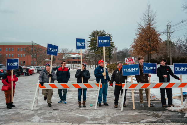 Supporters of Republican presidential candidate Donald Trump demonstrate outside the Pinkerton Academy high school polling place.