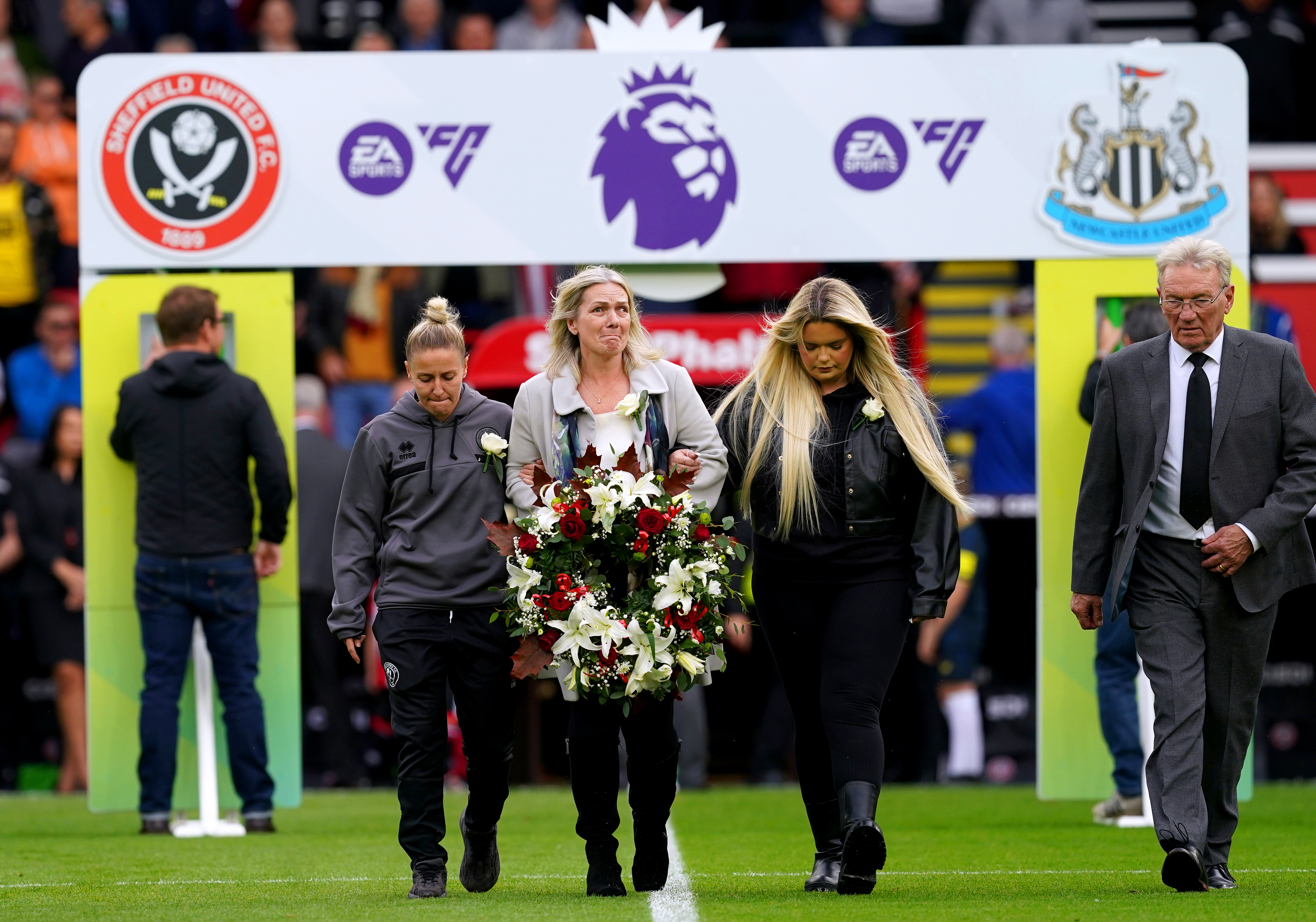 Former Sheffield United player Tony Currie, Sheffield United women’s Sophie Barker and Maddy Cusack’s mum and sister laid a wreath in memory of her