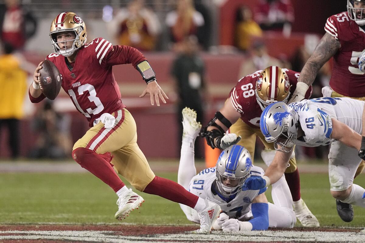 San Francisco 49ers quarterback Brock Purdy (13) runs against Detroit Lions in the NFC championship game.