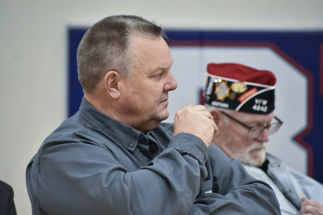 Sen. Jon Tester listens to a speaker at Bigfork High School in Bigfork, Mont.