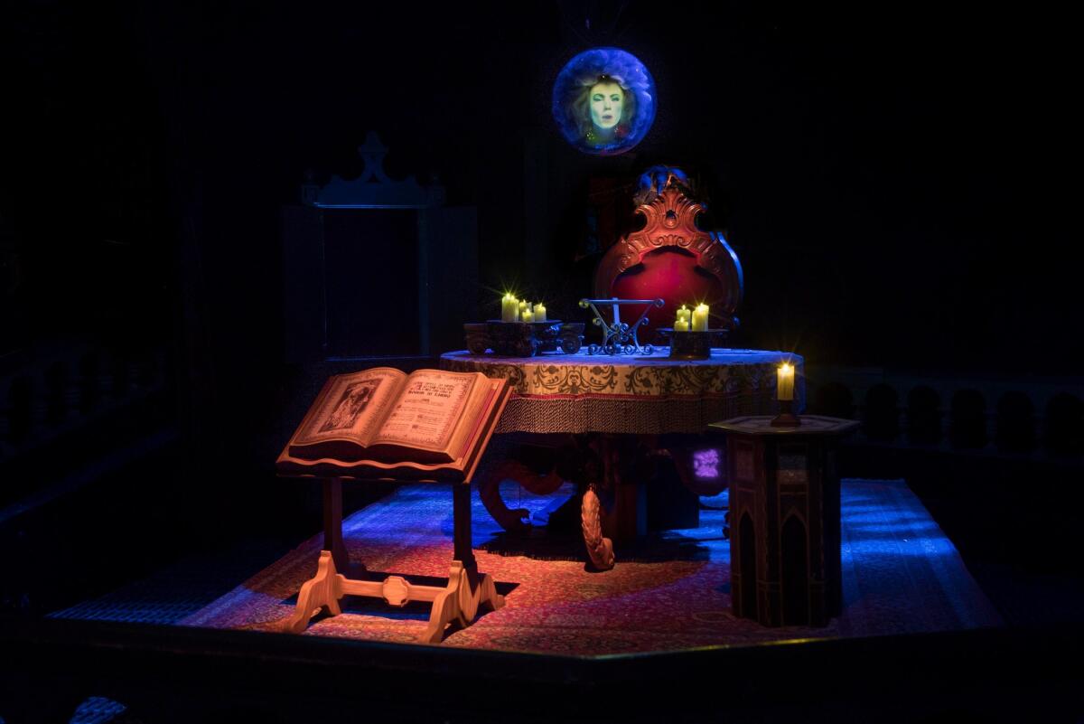 A mysterious séance room in which a woman's head glows in a see-through sphere. 